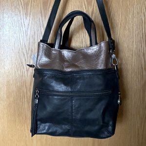 Leather crossbody purse with reshaping features.